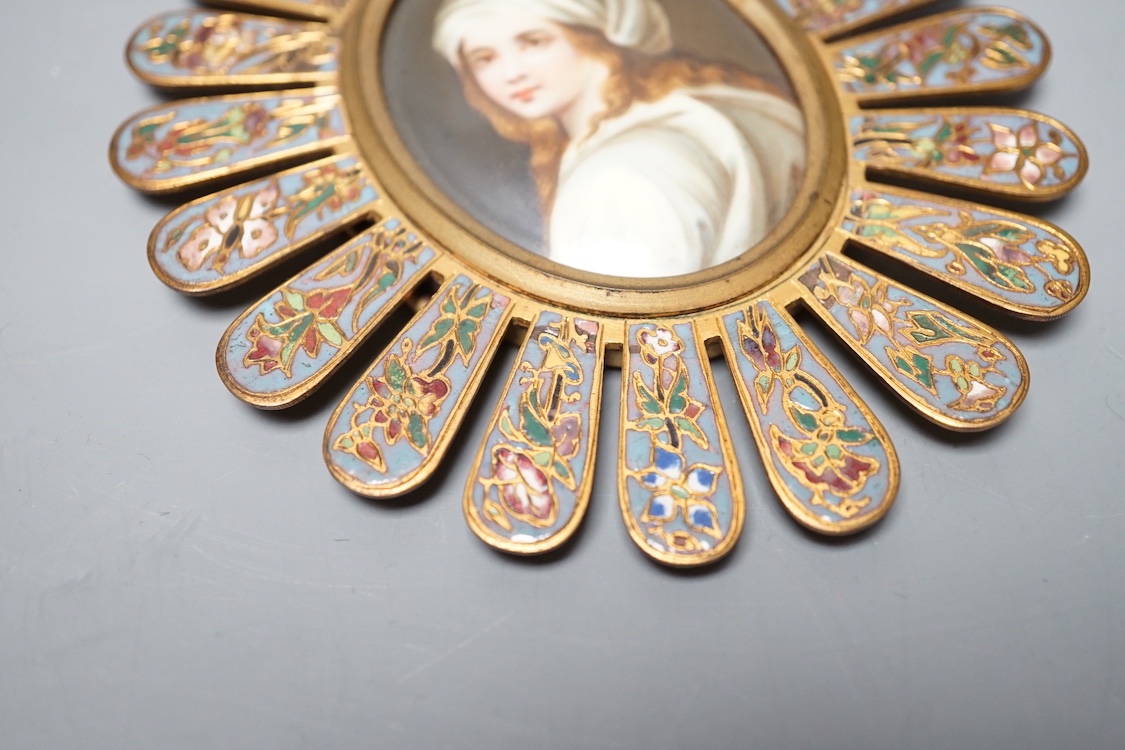 An 19th century Paris porcelain portrait miniature of a lady in a champleve enamelled frame. 13.5cm total exterior frame length